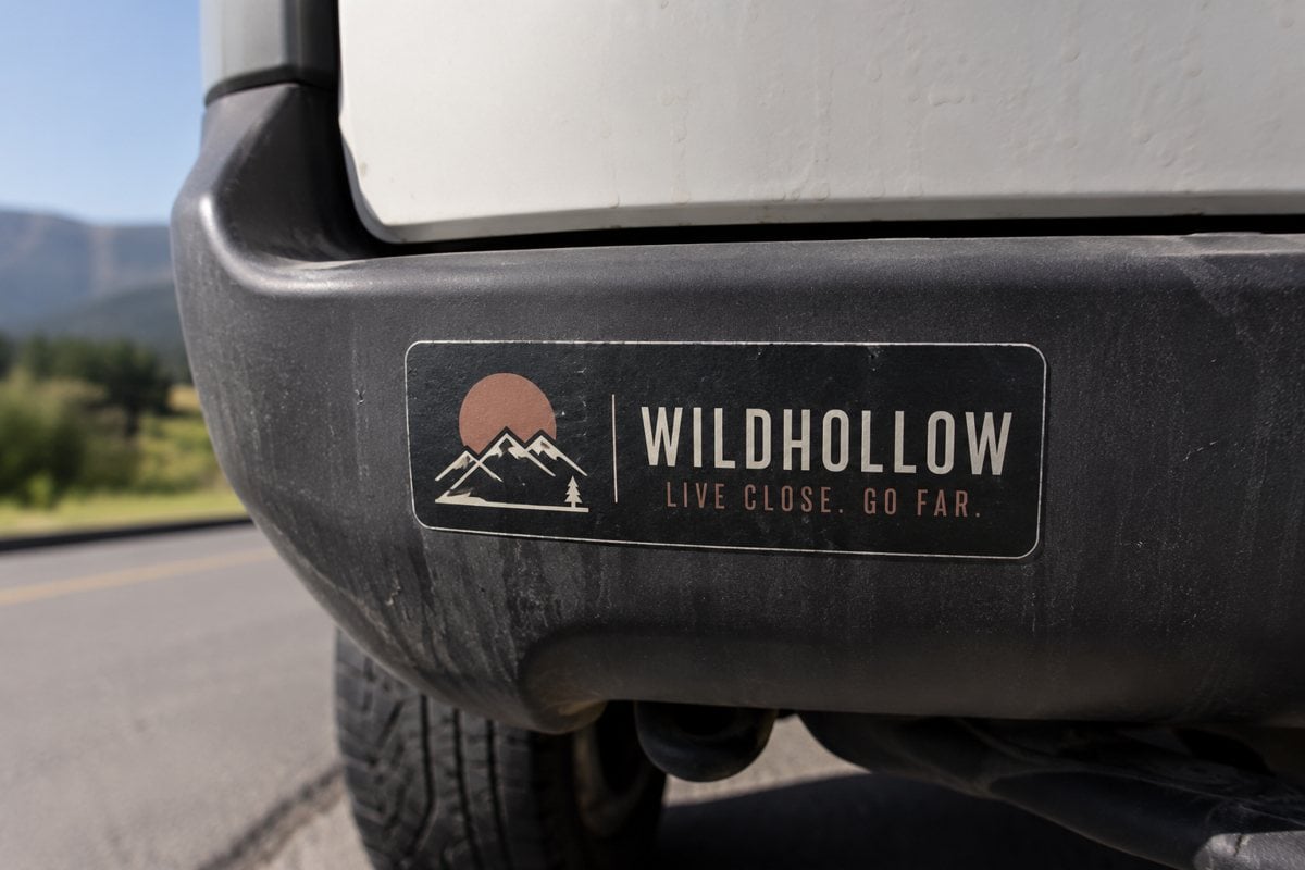 Weatherproof rectangular bumper sticker printed with an invented brand slogan on a car